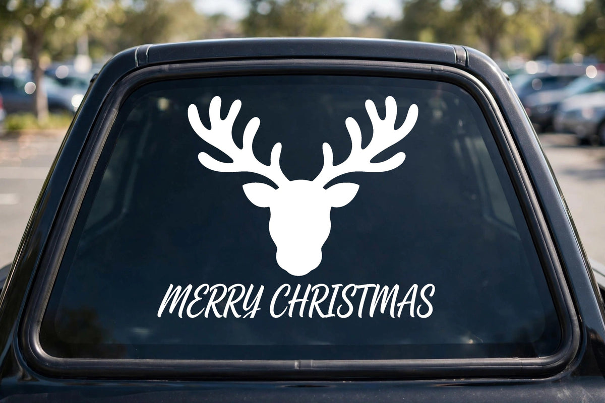 Merry Christmas Reindeer decal applied to a truck rear window